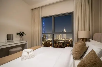 a bedroom with a large window with a city view at Elegant 3 BR - Stunning Burj Khalifa Views in Dubai