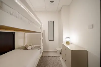 a bedroom with two bunk beds and a desk at Elegant 3 BR - Stunning Burj Khalifa Views in Dubai