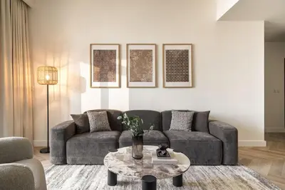 a living room with a couch and a table at Elegant 3 BR - Stunning Burj Khalifa Views in Dubai
