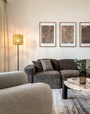 a living room with a couch and a table at Elegant 3 BR - Stunning Burj Khalifa Views in Dubai