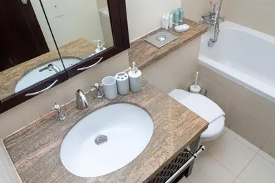 a bathroom with a sink and a toilet and a mirror at 3BR Luxury Burj Residence Full Burj Khalifa in Dubai