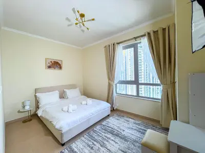 a bedroom with a white bed and a window at 3BR Luxury Burj Residence Full Burj Khalifa in Dubai
