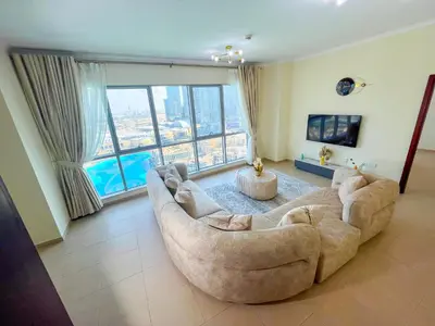 a living room with a large couch and a large window at 3BR Luxury Burj Residence Full Burj Khalifa in Dubai