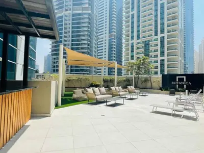 a patio with couches and tables in a city at Prime Location - Dubai Marina 1br - King Size Bed in Dubai