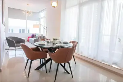 a dining room with a table and chairs at Prime Location - Dubai Marina 1br - King Size Bed in Dubai