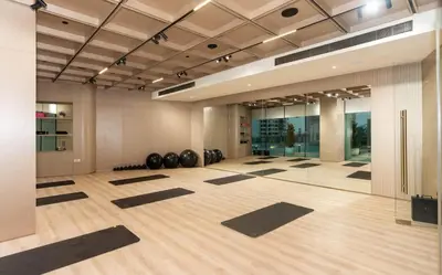 a yoga room with black mats on the floor at Binghatti Phantom 1BR Luxe Suite with Private Pool in Dubai
