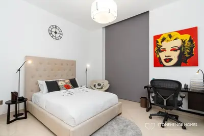 a bedroom with a bed and a desk and a chair at Sky-High 3BR in Trident Grand Residence in Dubai Marina & JBR with Epic Sea, Palm & Dubai Eye View in Dubai