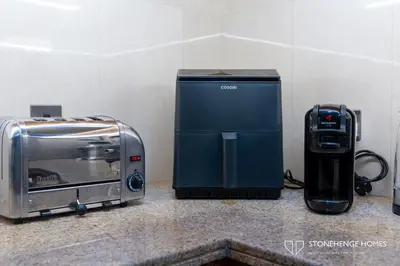 a toaster and a toaster oven sitting on a counter at Sky-High 3BR in Trident Grand Residence in Dubai Marina & JBR with Epic Sea, Palm & Dubai Eye View in Dubai