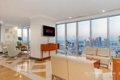 a living room with a view of a city at Sky-High 3BR in Trident Grand Residence in Dubai Marina & JBR with Epic Sea, Palm & Dubai Eye View in Dubai