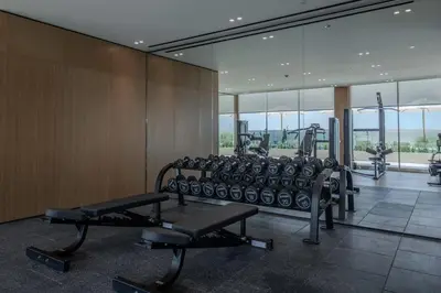 a gym with treadmills and machines in a room at Beautifully Furnished Studio in Binghatti Azure in Dubai