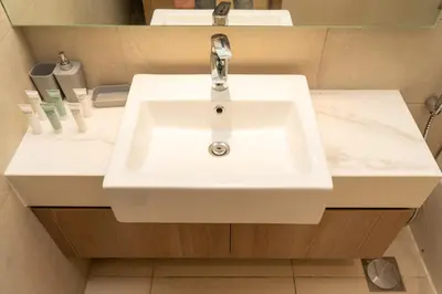 a white sink in a bathroom with a mirror at 2 Bedroom Luxury In Jaddaf in Dubai