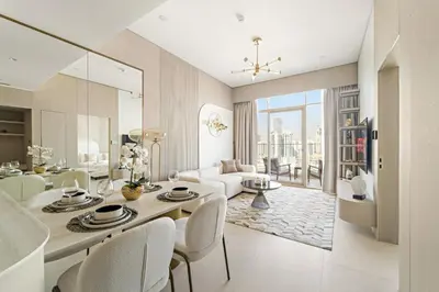 a white living room with a table and chairs at VayK - Modern & Elegant 1BD in JVC in Dubai