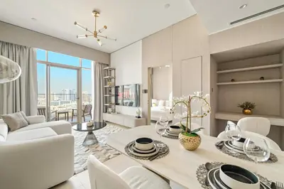 a living room with a table and chairs and a dining room at VayK - Modern & Elegant 1BD in JVC in Dubai