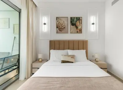 a bedroom with a large white bed and a balcony at 4-BR Luxury Retreat with Iconic Burj Khalifa View in Dubai