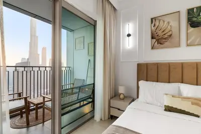 a bedroom with a bed and a balcony with a view at 4-BR Luxury Retreat with Iconic Burj Khalifa View in Dubai