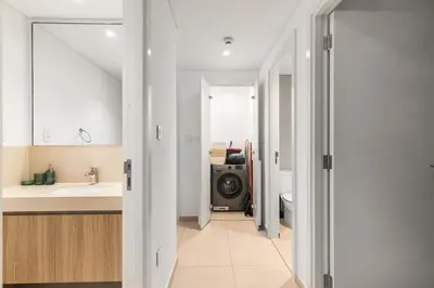 a bathroom with a sink and a washing machine at 4-BR Luxury Retreat with Iconic Burj Khalifa View in Dubai