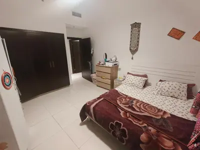 a bedroom with a bed and a dresser at Furnished 2 Bedroom Apartment with Balconies in Dubai