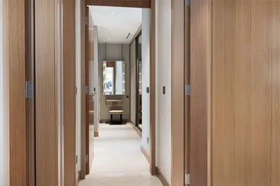 a hallway with wooden doors and a hallway with a hallway at Address Opera by NAMUVE in Dubai