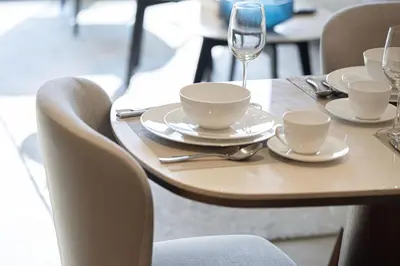 a table with plates and cups and a wine glass at Address Opera by NAMUVE in Dubai