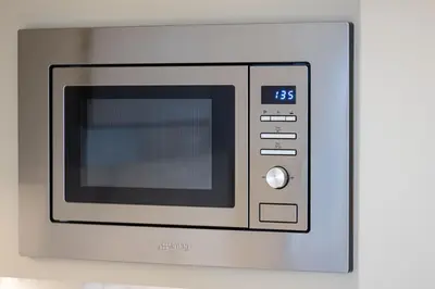 a microwave oven sitting on top of a wall at Address Opera by NAMUVE in Dubai