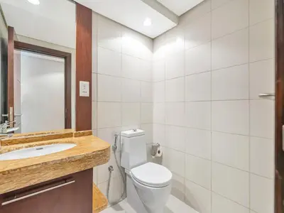 a bathroom with a toilet sink and a mirror at Skyline Upscale 2 Bedroom Apartment I Steps to Burj Khalifa Dubai Fountain Dubai Mall I Mesmerizing Views I Free Gym, Pool, Parking & Wi-Fi in Dubai