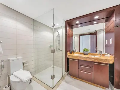 a bathroom with a shower and a toilet and a sink at Skyline Upscale 2 Bedroom Apartment I Steps to Burj Khalifa Dubai Fountain Dubai Mall I Mesmerizing Views I Free Gym, Pool, Parking & Wi-Fi in Dubai