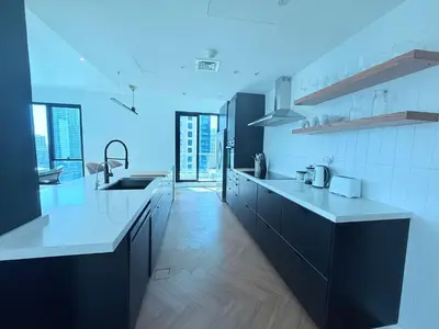 a kitchen with black and white counter tops in a kitchen at Luxury Upgraded 2BR in Dubai Marina in Dubai