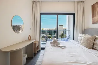 a bedroom with a large bed and a large window at Modern 2 Bedroom Apartment in Sobha Hartland in Dubai