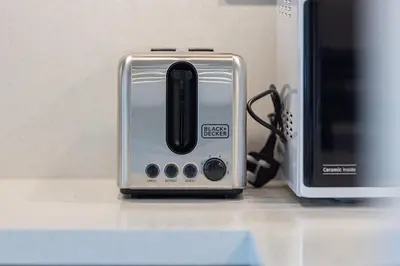 a toaster sitting on a counter next to a microwave at Modern 2 Bedroom Apartment in Sobha Hartland in Dubai