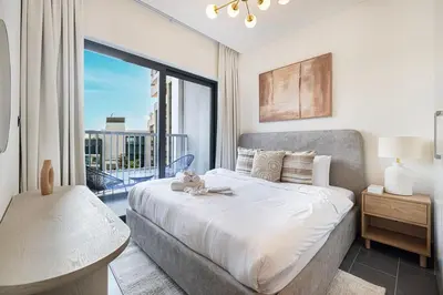 a bedroom with a large bed and a large window at Modern 2 Bedroom Apartment in Sobha Hartland in Dubai