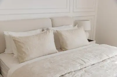 a white bed with white pillows on top of it at Beautiful 1 bed in JBR! in Dubai