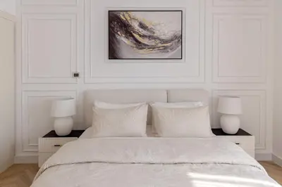 a white bedroom with two lamps and a bed at Beautiful 1 bed in JBR! in Dubai
