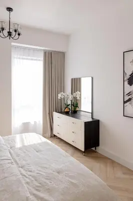 a white bedroom with a bed and a mirror at Beautiful 1 bed in JBR! in Dubai