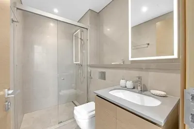 a bathroom with a sink and a shower and a toilet at Two Bedroom in Sobha Waves in Dubai