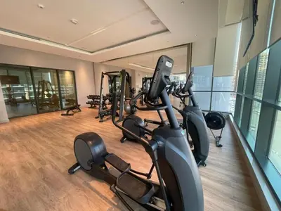 a gym with several exercise bikes in a room at Two Bedroom in Sobha Waves in Dubai