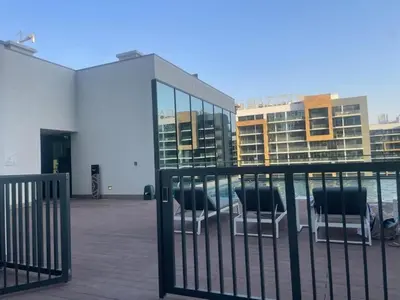 a group of chairs sitting in front of a building at Two Bedroom in Sobha Waves in Dubai
