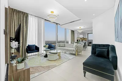 a living room filled with furniture and a large window at Two Bedroom in Sobha Waves in Dubai