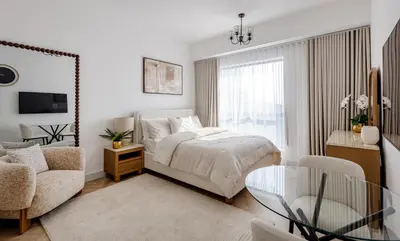 a bedroom with a bed and a glass table at Stylish Studio with Marina View JBR in Dubai