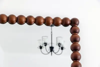 a wooden garland with a chandelier in the background at Stylish Studio with Marina View JBR in Dubai