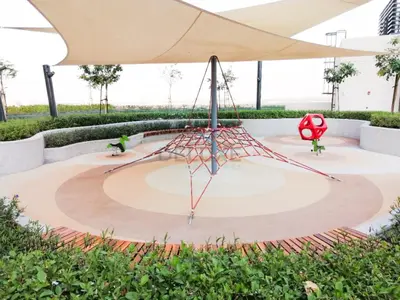 a sculpture in a garden with an umbrella at Harbour-View 3BR with Assistant Room, Just a Stones Throw from Marine Transportation, Harbour Gate Tower 1, Creek Harbour by Deluxe Holiday Homes in Dubai