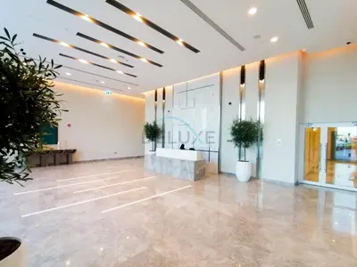 a large room with a lobby with potted plants at Harbour-View 3BR with Assistant Room, Just a Stones Throw from Marine Transportation, Harbour Gate Tower 1, Creek Harbour by Deluxe Holiday Homes in Dubai