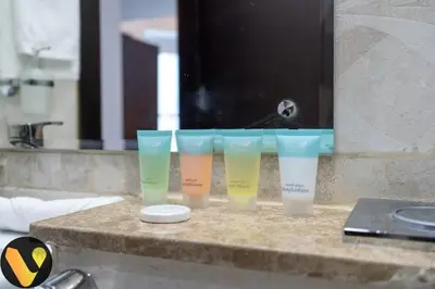 a group of four plastic cups sitting on a counter at Vogue Business Bay Court Tower close to Downtown Burj Khalifa and Dubai Mall, Studio Apartment with Canal view in Dubai