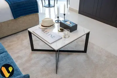 a table with a hat and a box on it at Vogue Business Bay Court Tower close to Downtown Burj Khalifa and Dubai Mall, Studio Apartment with Canal view in Dubai