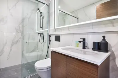a bathroom with a toilet and a sink and a shower at STAY BY LATINEM Luxury 1BR Holiday Home CD 0602 Near Burj Khalifa in Dubai