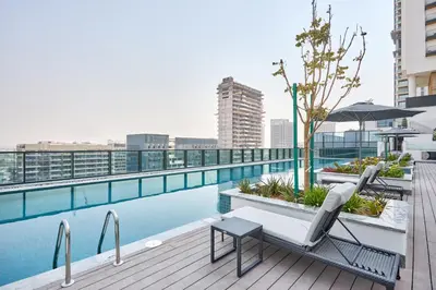 a pool on the roof of a building at STAY BY LATINEM Luxury 1BR Holiday Home CD 0602 Near Burj Khalifa in Dubai
