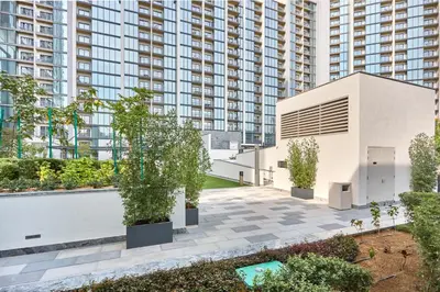 an apartment courtyard with trees and a building at STAY BY LATINEM Luxury 1BR Holiday Home CD 0602 Near Burj Khalifa in Dubai