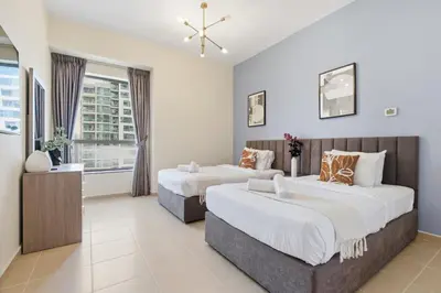 a hotel room with two beds and a window at Rimal 1, JBR - 2 Bedroom Apartment - Allsopp & Allsopp in Dubai