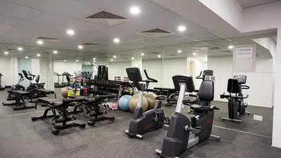 a gym with several rows of exercise bikes and treadms at Rimal 1, JBR - 2 Bedroom Apartment - Allsopp & Allsopp in Dubai