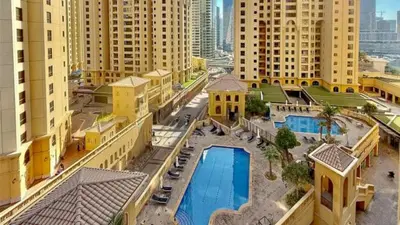 an aerial view of a building with a swimming pool at Rimal 1, JBR - 2 Bedroom Apartment - Allsopp & Allsopp in Dubai