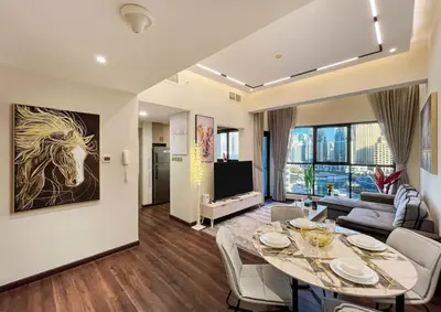 a living room with a dining table and a couch at Brand New Two Bedrooms Apartment With Amazing Marina View in Dubai